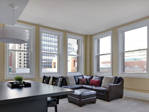 Two-bedroom corner living and dining room with skyline views
