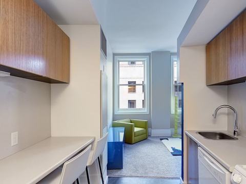 Galley kitchen leading to living room