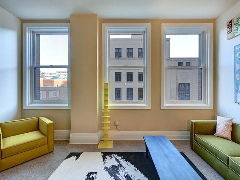 Living area with historic windows and city views